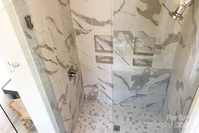 bathroom with a tile shower