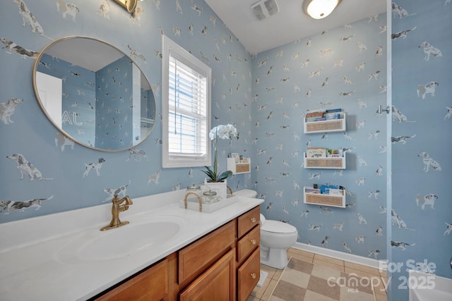 bathroom with tile patterned flooring, vanity, and toilet