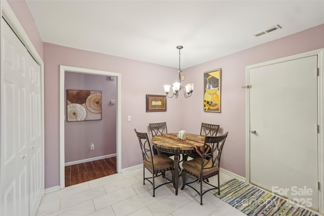 tiled dining area with a notable chandelier