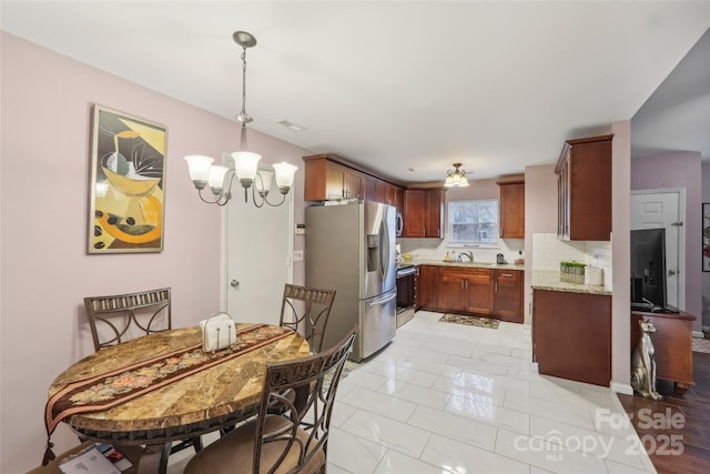 dining space featuring light tile patterned flooring and an inviting chandelier