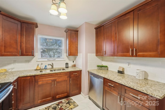 kitchen with light stone countertops, stainless steel appliances, tasteful backsplash, and sink