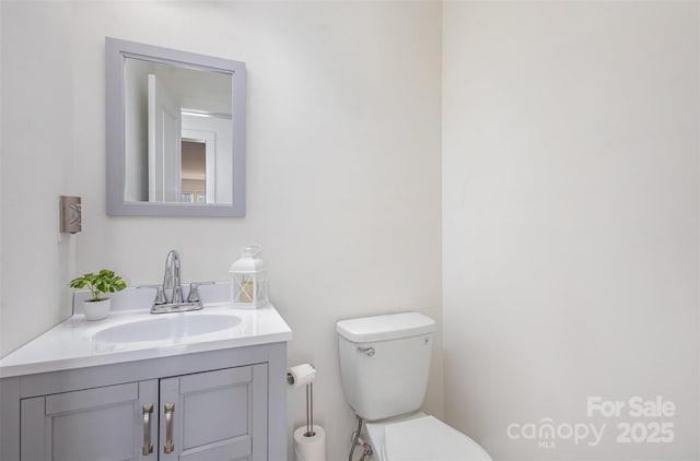 bathroom with toilet and vanity