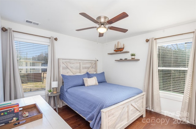 bedroom with ceiling fan and dark wood-type flooring