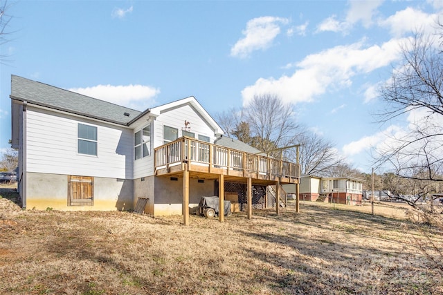 back of property featuring a wooden deck