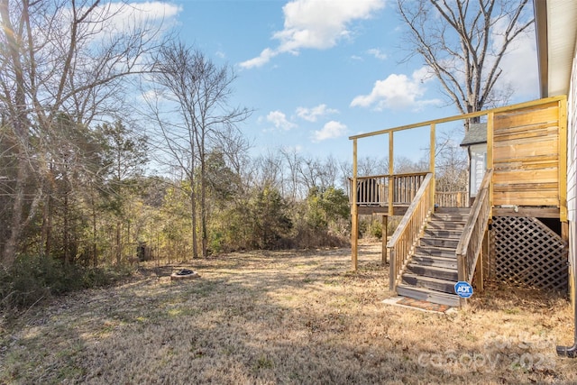 view of yard featuring an outdoor fire pit and a wooden deck