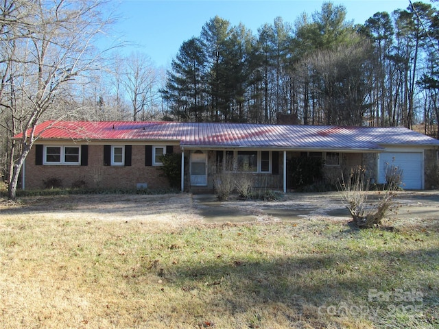 single story home with a front lawn and a garage