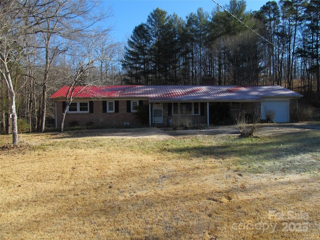 ranch-style home with a porch, a garage, and a front yard