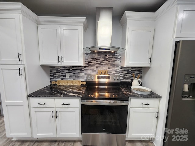 kitchen with backsplash, appliances with stainless steel finishes, wall chimney exhaust hood, and white cabinetry