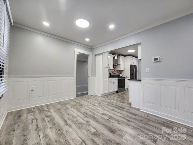 interior space featuring crown molding and light wood-type flooring