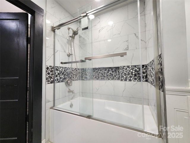 bathroom with shower / bath combination with glass door