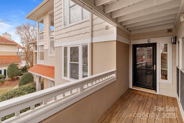 property entrance featuring visible vents and a balcony