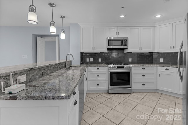 kitchen with white cabinets, light tile patterned flooring, stainless steel appliances, and a sink