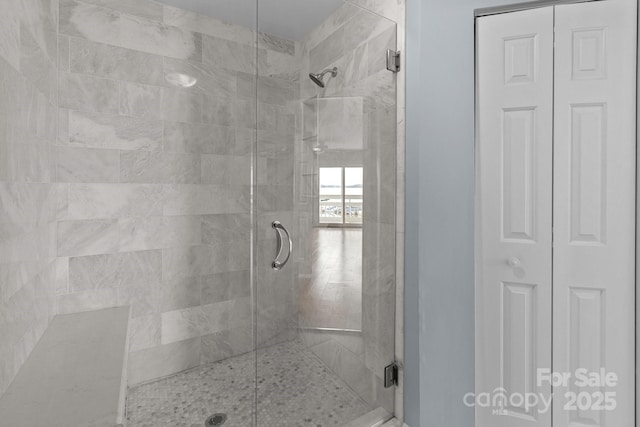 full bathroom featuring a closet and a stall shower