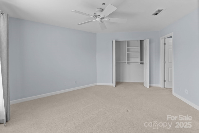 unfurnished bedroom featuring baseboards, visible vents, a closet, and carpet flooring