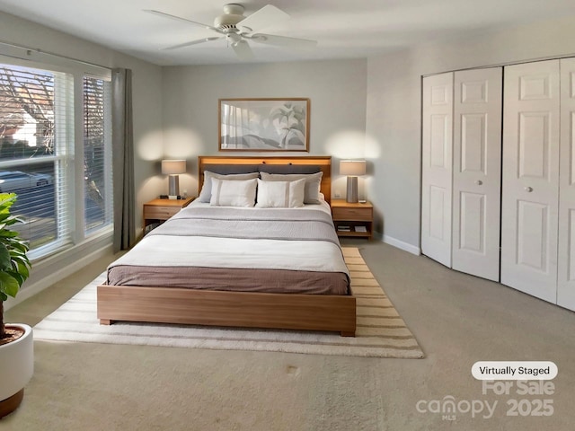 carpeted bedroom with baseboards, a ceiling fan, and a closet