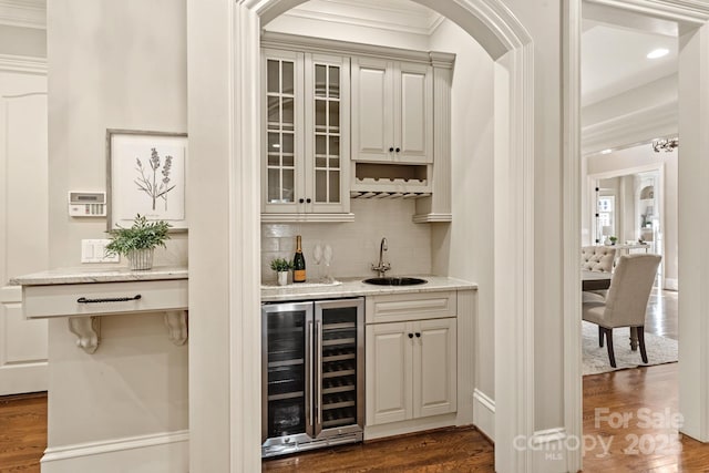 bar featuring sink, beverage cooler, dark hardwood / wood-style floors, and tasteful backsplash