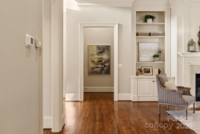 interior space featuring built in shelves and dark hardwood / wood-style flooring