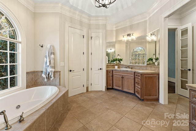 bathroom featuring a notable chandelier, a relaxing tiled tub, tile patterned floors, and vanity