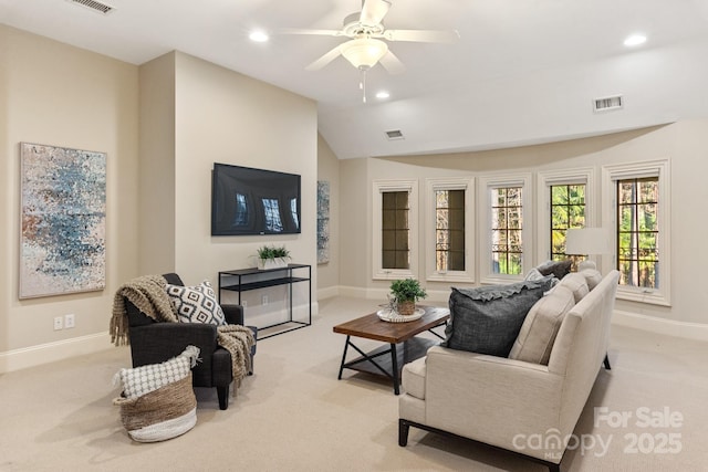 living room featuring vaulted ceiling, ceiling fan, and light colored carpet