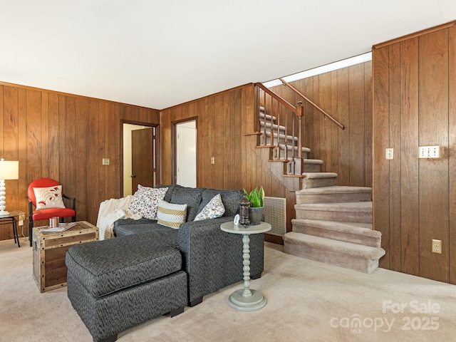 carpeted living room with wooden walls