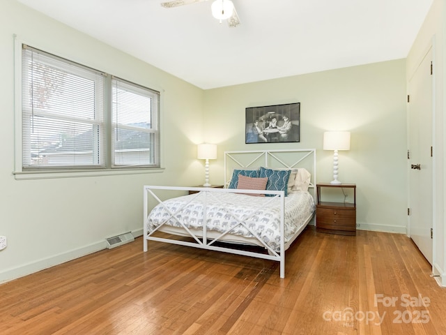 bedroom with ceiling fan and wood-type flooring