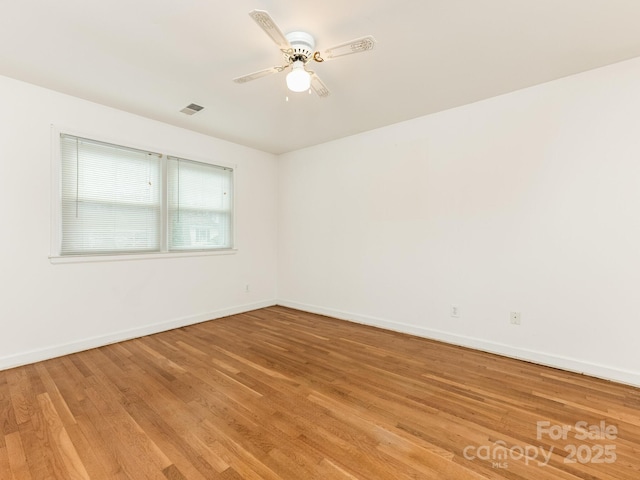 unfurnished room featuring hardwood / wood-style floors and ceiling fan