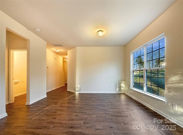 empty room featuring dark wood-type flooring