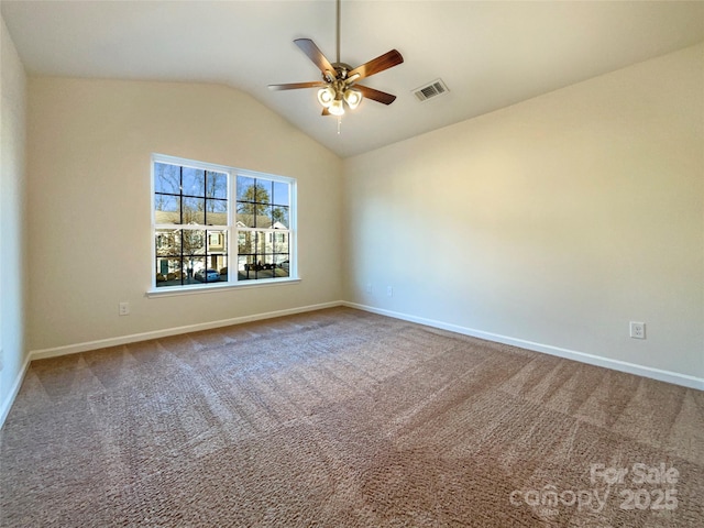 carpeted empty room with ceiling fan and lofted ceiling