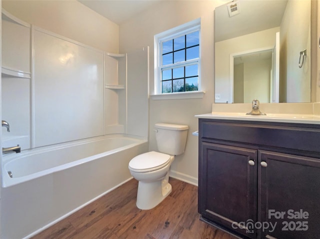 full bathroom featuring vanity, wood-type flooring,  shower combination, and toilet