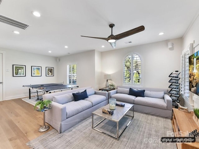 living room with ceiling fan and light hardwood / wood-style floors