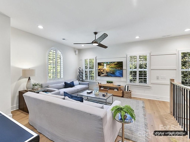 living room featuring ceiling fan and light wood-type flooring