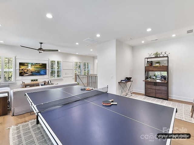 recreation room with ceiling fan and light hardwood / wood-style flooring