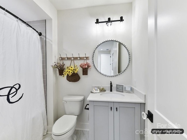 bathroom featuring vanity and toilet