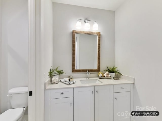 bathroom featuring vanity and toilet