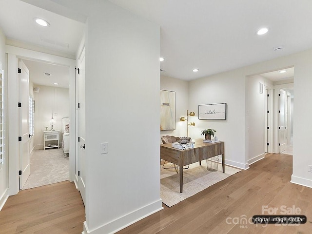 corridor with light hardwood / wood-style flooring