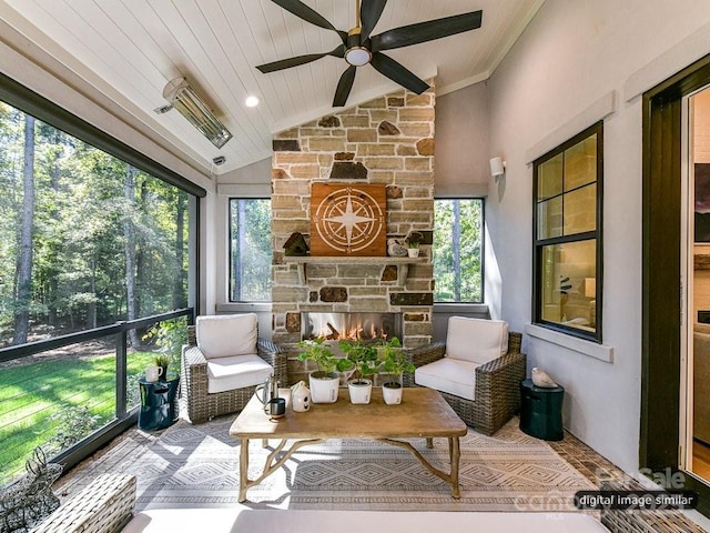 sunroom featuring ceiling fan, a fireplace, wooden ceiling, and vaulted ceiling