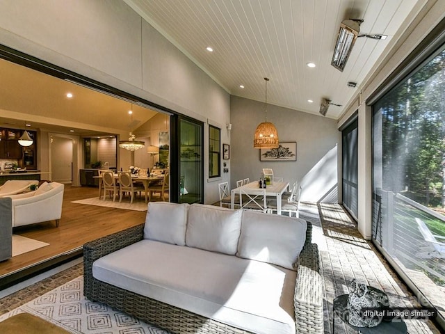 sunroom / solarium featuring a wealth of natural light, wooden ceiling, and lofted ceiling