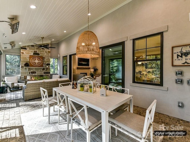 dining room with a fireplace, ceiling fan, lofted ceiling, and wood ceiling