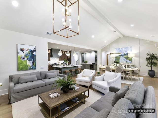 living room with light wood-style flooring, a chandelier, and baseboards