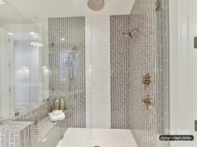 full bath with a tile shower