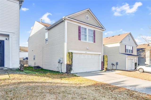 view of front of property featuring a garage and central AC unit