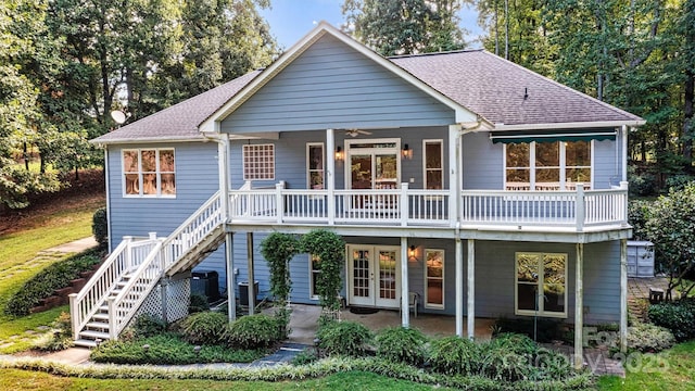 rear view of property featuring french doors and ceiling fan