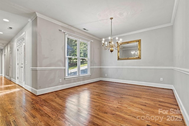 unfurnished dining area featuring crown molding, a chandelier, and hardwood / wood-style flooring