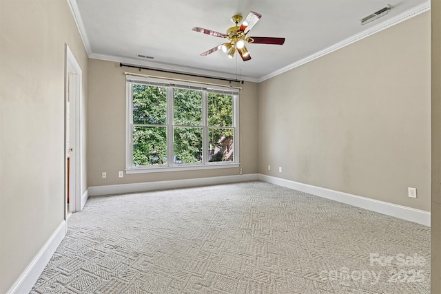 carpeted spare room featuring ceiling fan and ornamental molding