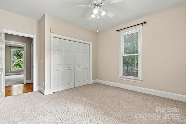 unfurnished bedroom with ceiling fan, a closet, and light colored carpet