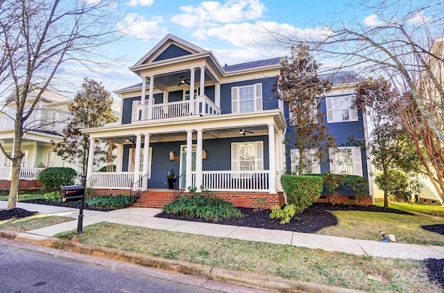 view of front facade with a porch, a balcony, and ceiling fan