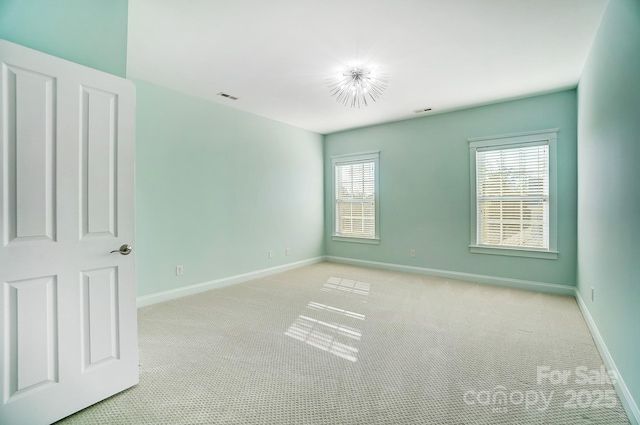 empty room featuring light colored carpet