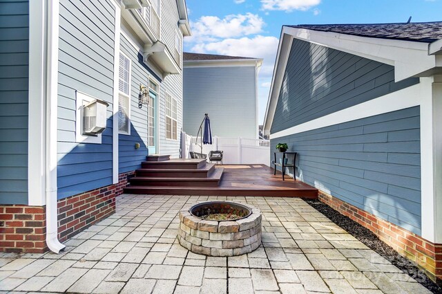 view of patio with an outdoor fire pit and a wooden deck