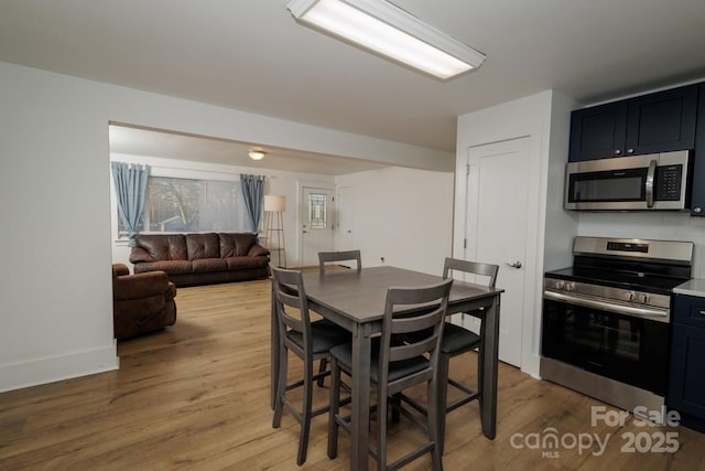 dining space with light hardwood / wood-style flooring