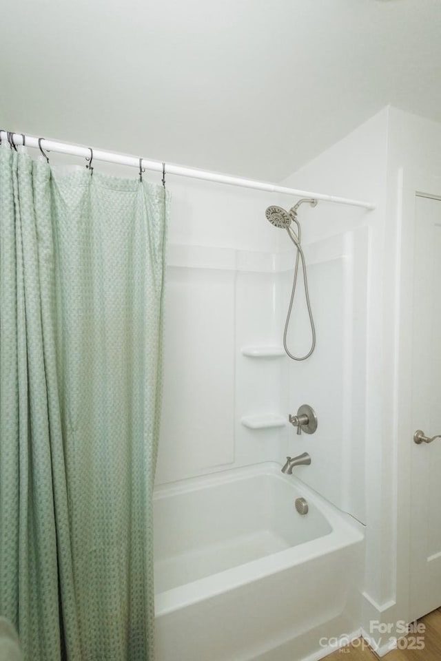 bathroom featuring shower / bathtub combination with curtain